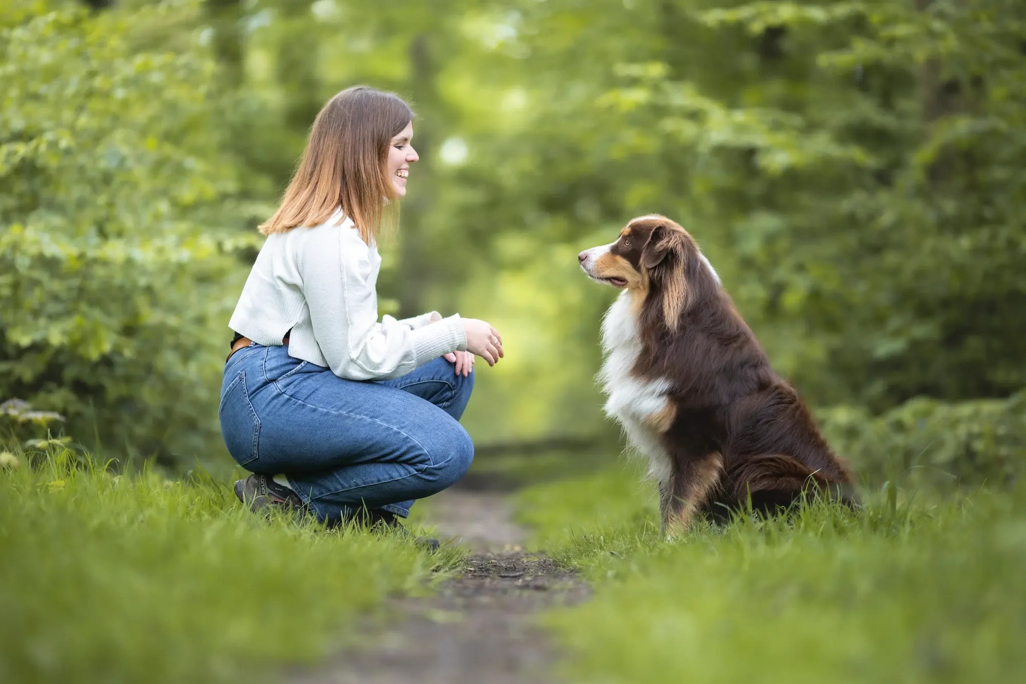 Éducatrice canine avec un chien dans un environnement naturel